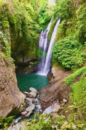 Man Standing in front of Aling Aling waterfall Bali, Indonesia