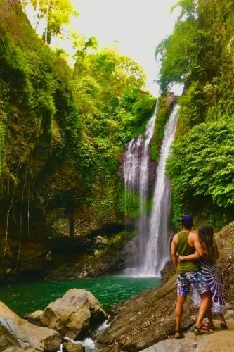 Couple admiring Aling Aling waterfall Bali, Indonesia