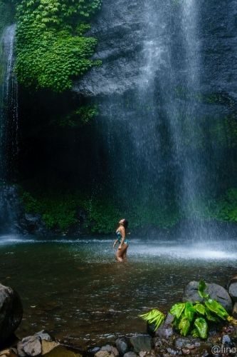 woman under Fiji Waterfall Bali Indonesia