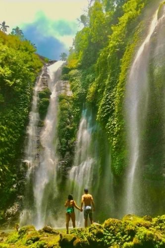 couple holding hands and admiring fiji waterfalls Bali, Indonesia