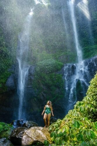 woman admiring Sekumpul waterfall bali, indonesia