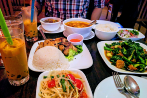 spicy Thai food dishes, papaya salad, tom yum soup, thai ice tea with boba